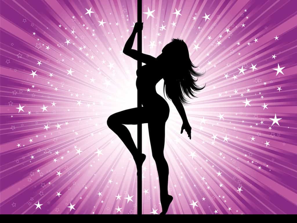 Silhouette of a sexy pole dancer performing