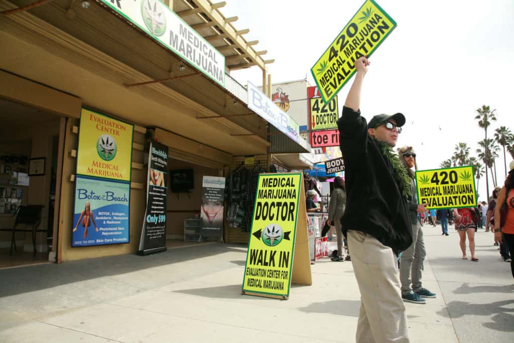 People hawk "Medical Marijuana" on the Venice Beach Board Walk