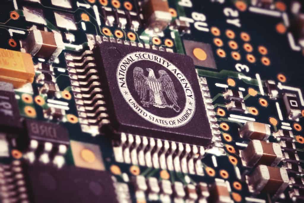 Illustration of a spying CPU inside a computer with the NSA logo on it.