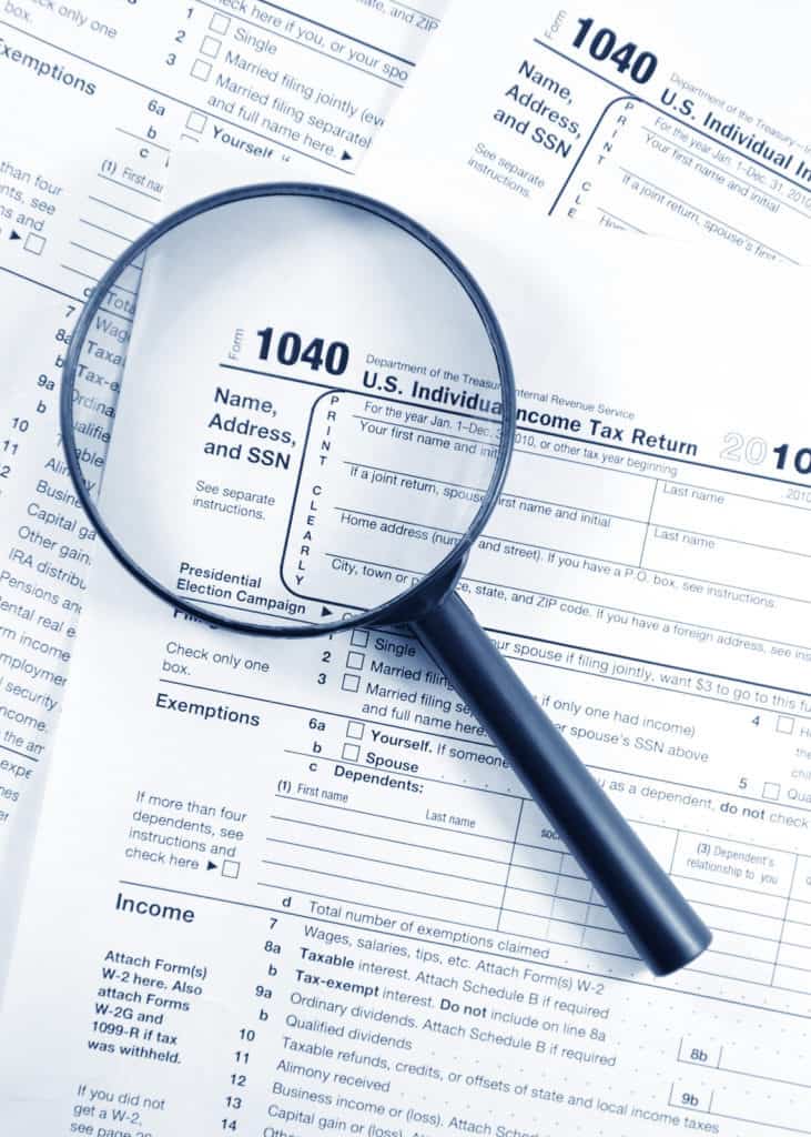 Save Download Preview Tax forms investigation concept with magnifying glass and 1040 US Income Tax Return