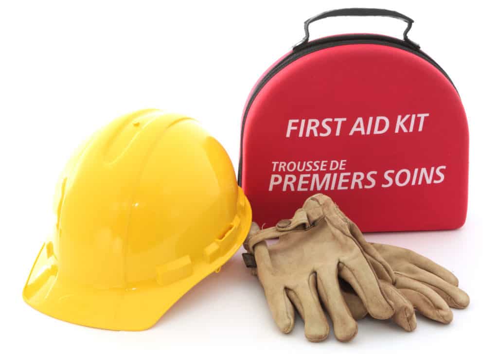 A first-aid kit hardhat and gloves spell out the need for safety in the workplace.