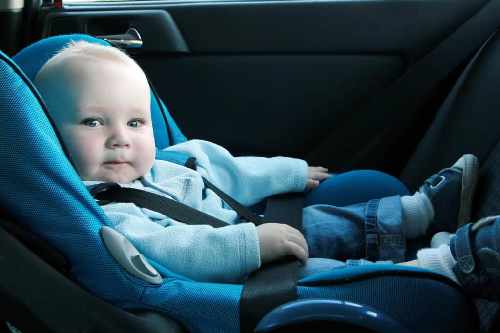 7 months old baby boy in a safety car seat.