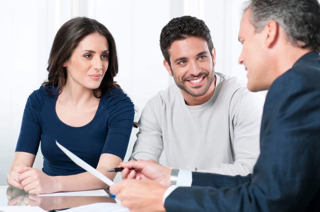 Financial consultant presents bank investments to a young couple