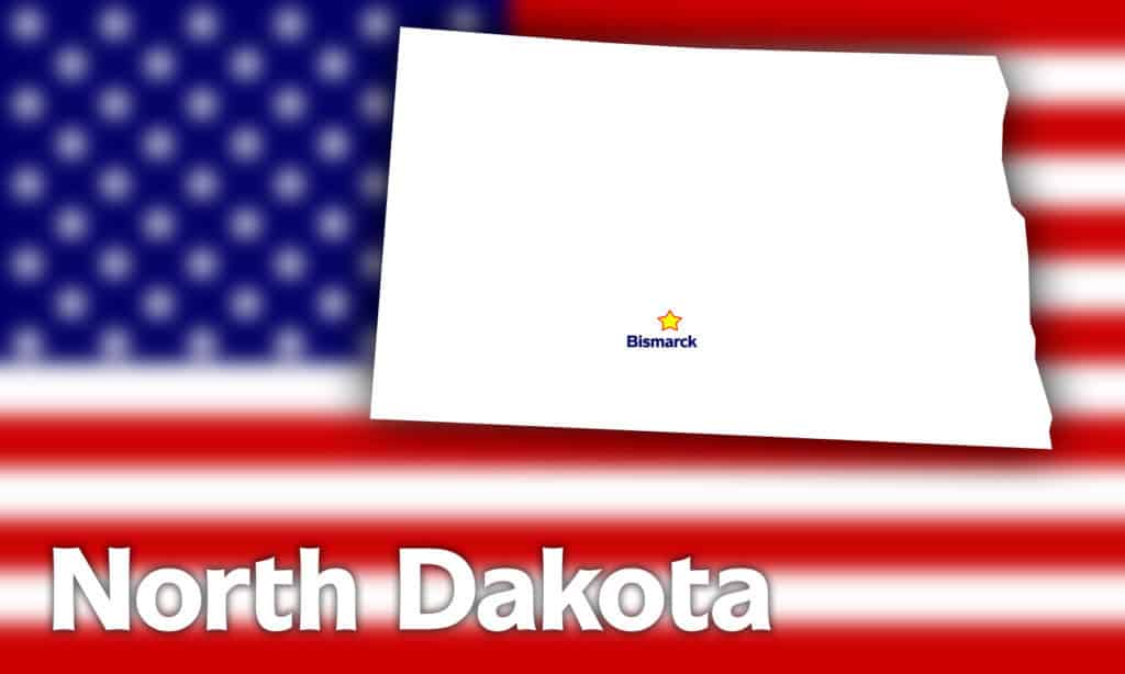 North Dakota state contour with Capital City against blurred USA flag