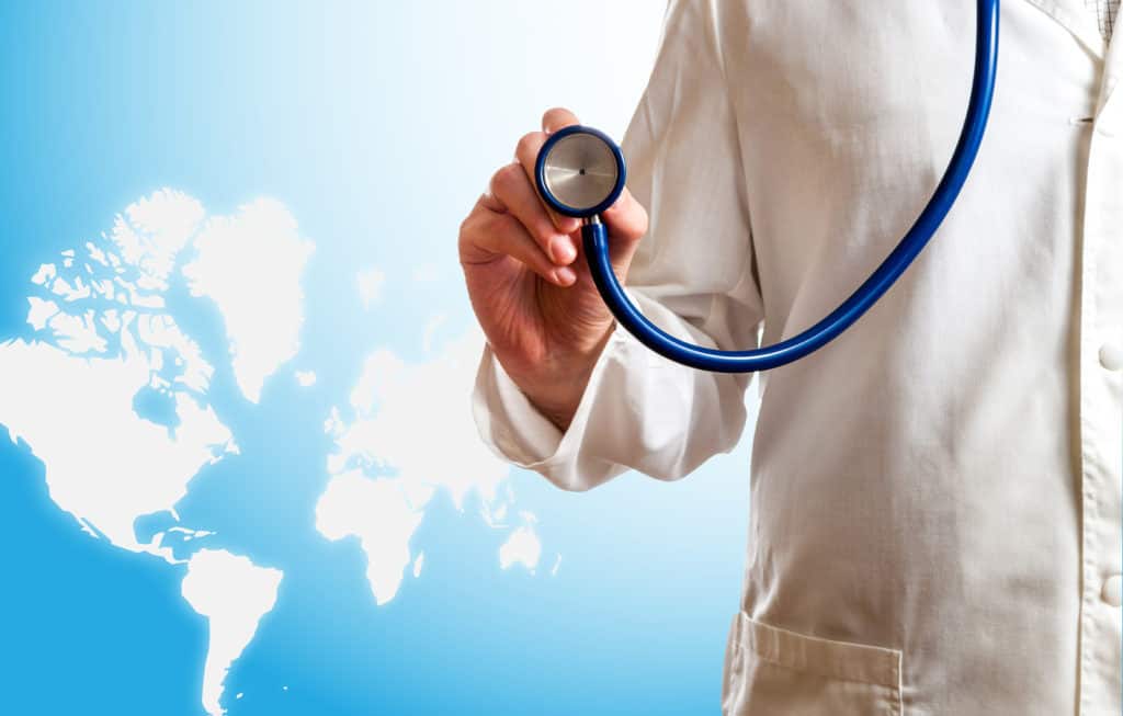 Medical Doctor With Stethoscope In Front Of World Map Map Traced From https://www.openstreetmap.org/#map=2/42.2/-9.8