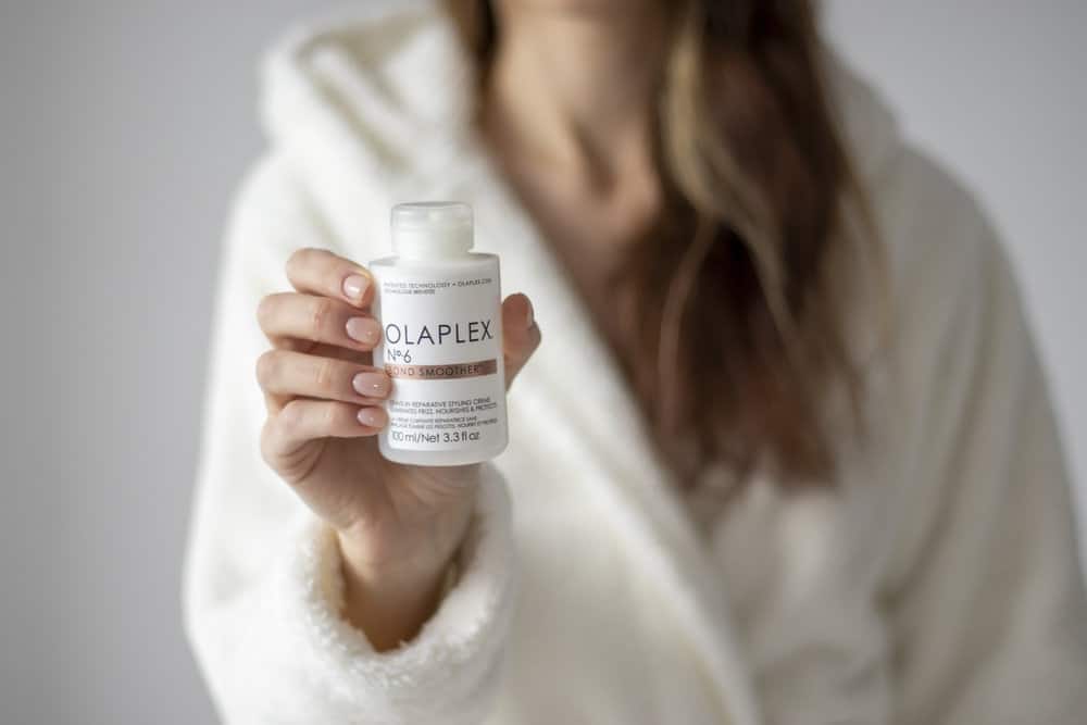 photo of woman holding olaplex no.6