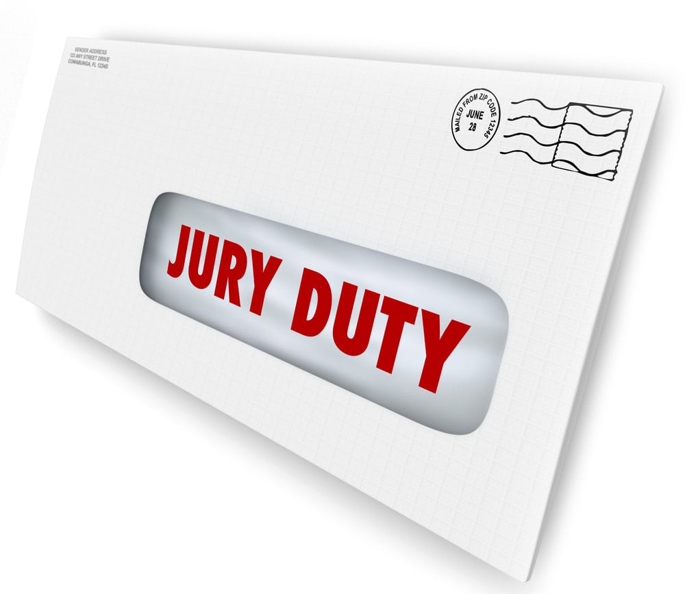 Jury Duty words on a letter in an envelope summoning you to appear in court to serve in judgment and render a legal judgment in a lawsuit or case