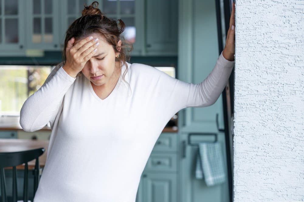 depo provera lawsuit image with woman with hand to her head.