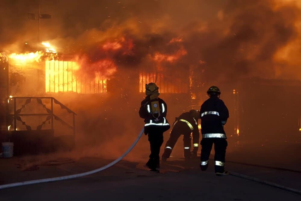 firefighters fighting burning home