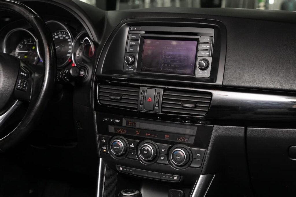 Interior view of a Mazda vehicle dashboard featuring the Mazda Connect infotainment system, center screen, and climate control interface.