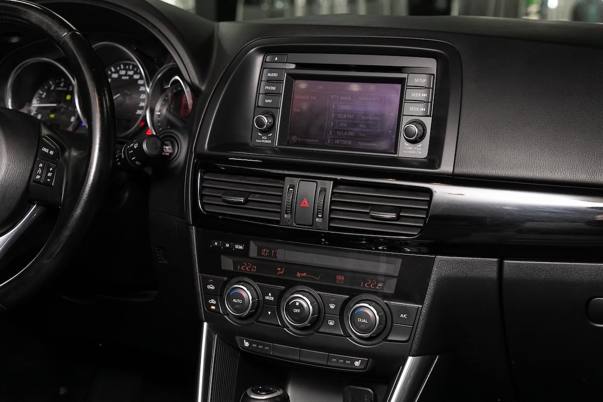 Interior view of a Mazda vehicle dashboard featuring the Mazda Connect infotainment system, center screen, and climate control interface.