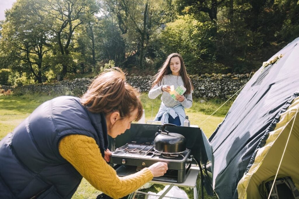 woman trying to light a camping stove