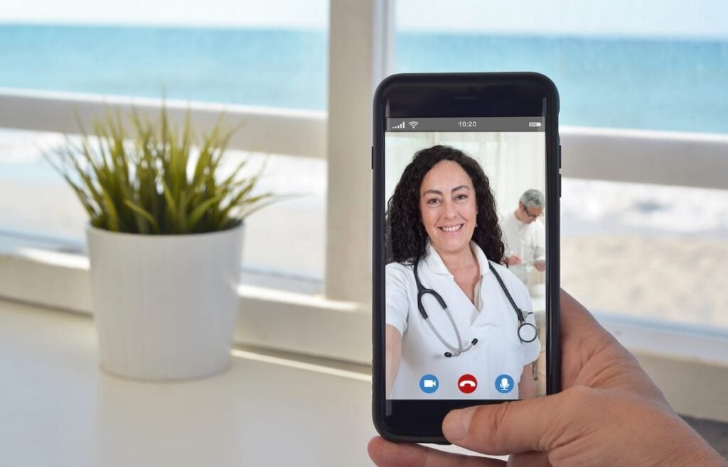 Patient on a telehealth video visit with a doctor using a smartphone app.